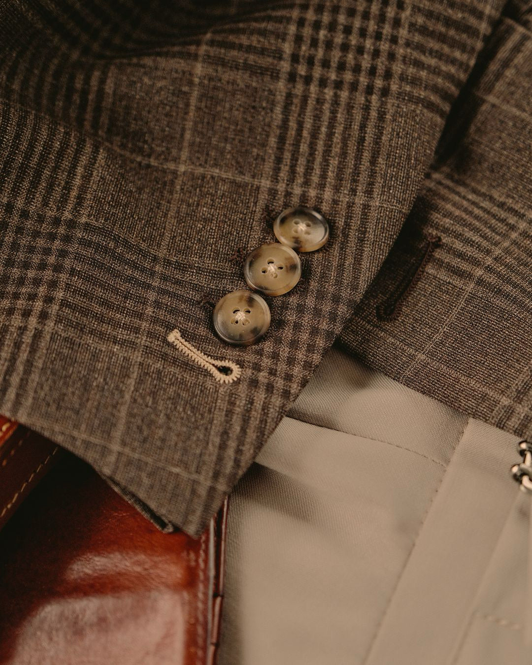 close up brown plaid blazer with constrasting button stitch made to measure